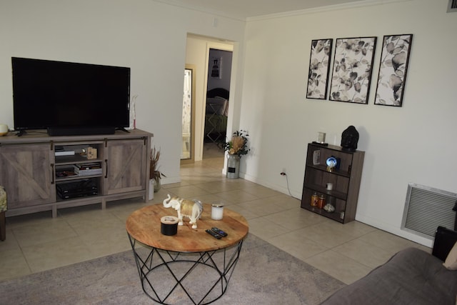 tiled living room featuring baseboards, visible vents, and crown molding