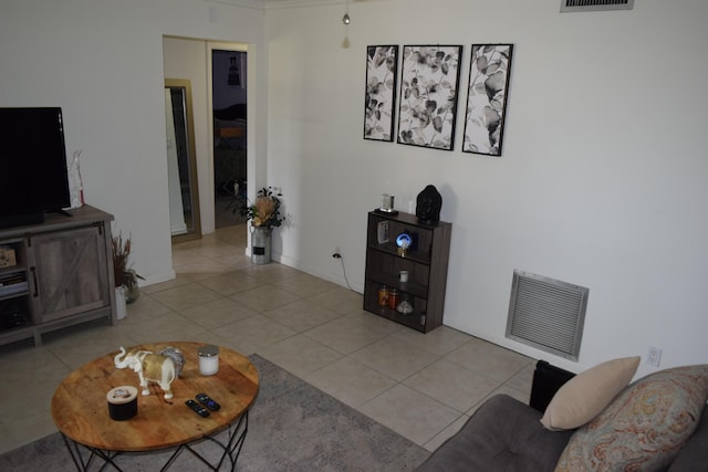 tiled living area with baseboards and visible vents