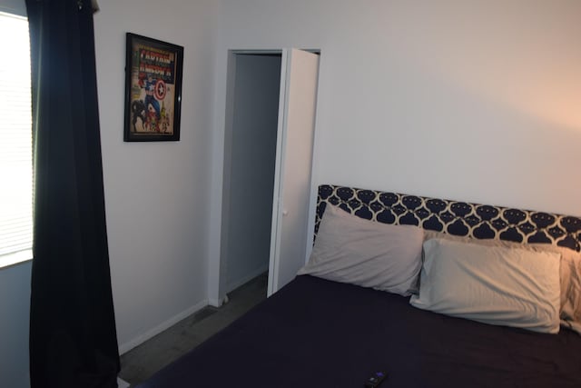 bedroom featuring multiple windows and baseboards