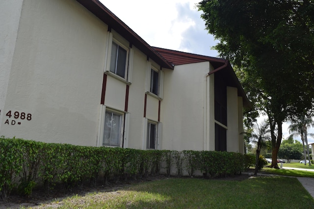 view of home's exterior featuring a yard and stucco siding