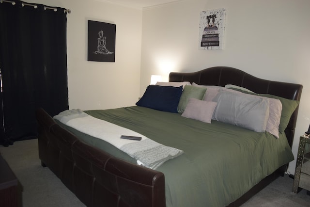 carpeted bedroom with ornamental molding