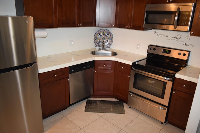 kitchen featuring light countertops, appliances with stainless steel finishes, and a sink