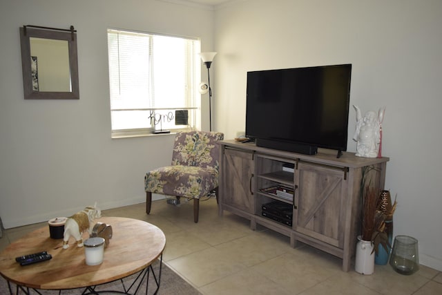 living room featuring baseboards and light tile patterned floors