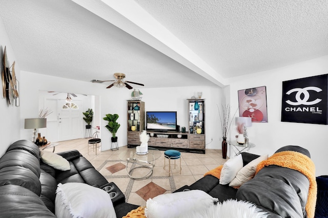 tiled living area featuring a textured ceiling and a ceiling fan