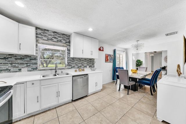 kitchen with visible vents, a sink, appliances with stainless steel finishes, white cabinets, and light countertops