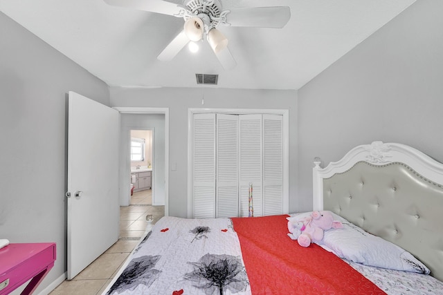 bedroom featuring light tile patterned floors, visible vents, a closet, and ceiling fan