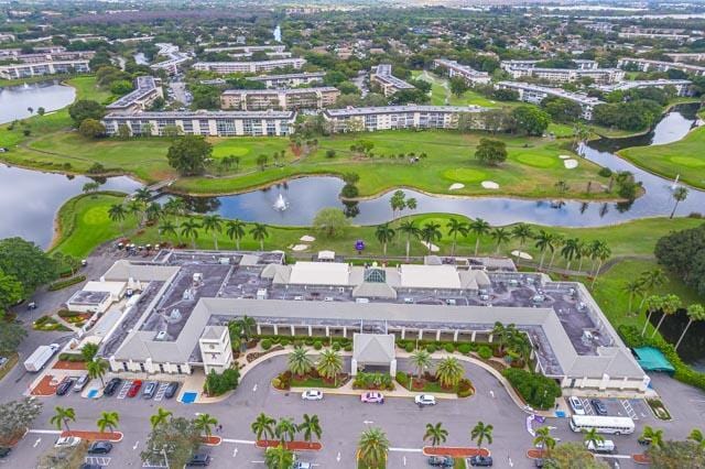 bird's eye view featuring golf course view and a water view