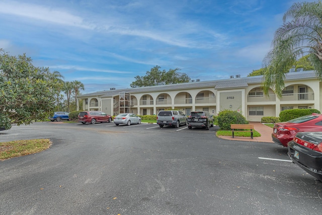 view of building exterior with uncovered parking