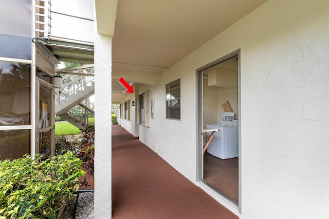 view of patio with washing machine and dryer and stairs