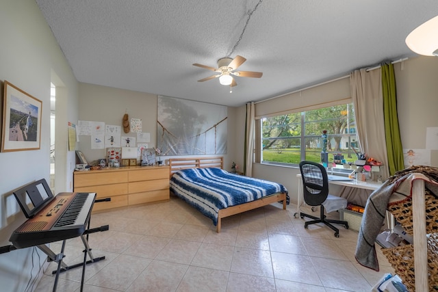 bedroom featuring a textured ceiling, ceiling fan, and light tile patterned floors