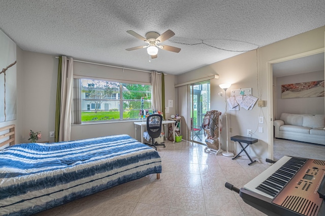 bedroom with a ceiling fan, a textured ceiling, and light tile patterned floors