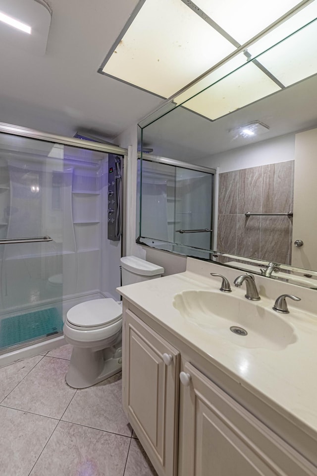 full bathroom with toilet, tile patterned flooring, a shower stall, and vanity