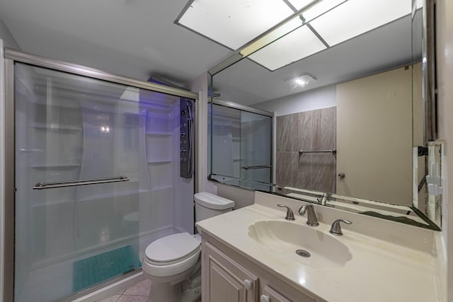 full bathroom with toilet, tile patterned floors, a stall shower, and vanity