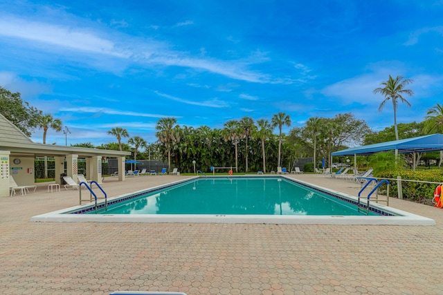 community pool featuring a patio area and fence