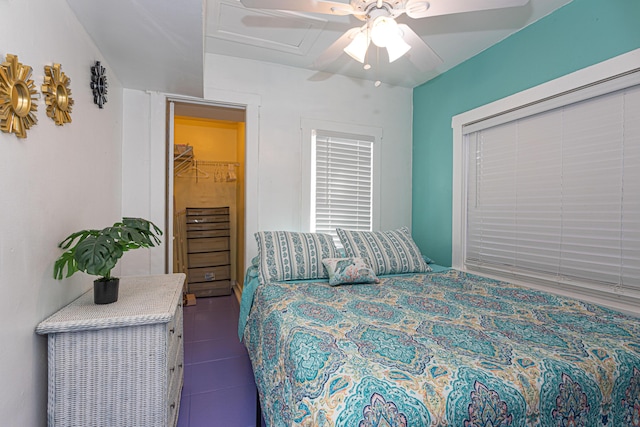 bedroom featuring attic access and ceiling fan