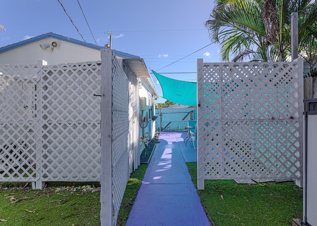 view of side of property with a patio and fence