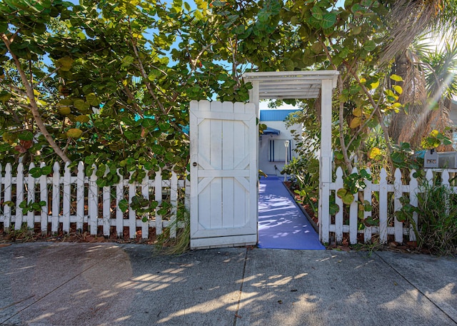 view of gate with a fenced front yard