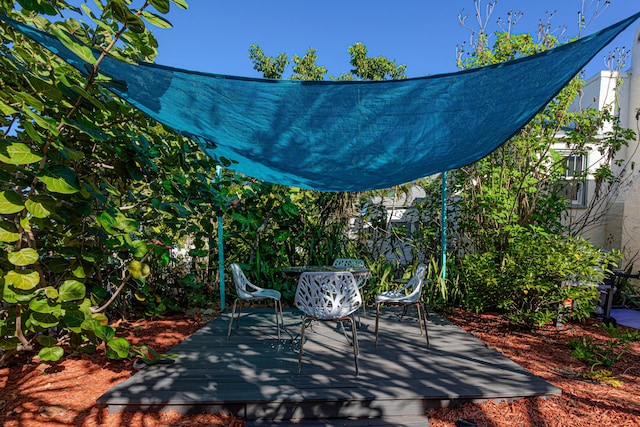 view of patio / terrace featuring outdoor dining space and a deck