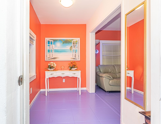 hall featuring baseboards and tile patterned floors