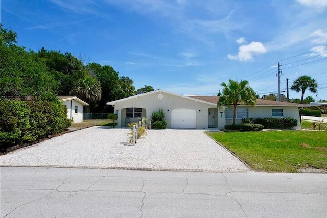 ranch-style home with stucco siding, an attached garage, decorative driveway, and a front lawn