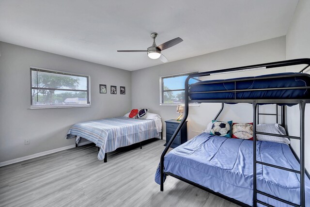 bedroom with visible vents, two closets, a notable chandelier, light wood-style floors, and baseboards