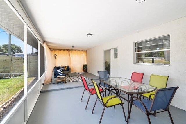 back of property with a patio, fence, a sunroom, and stucco siding