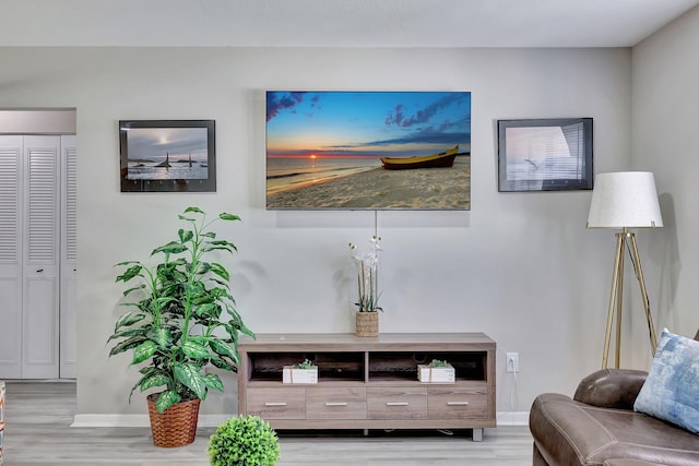 interior space featuring wood finished floors and baseboards