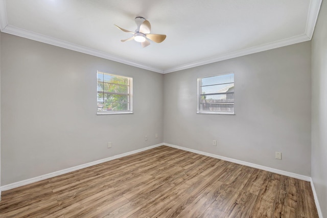 spare room featuring ceiling fan, baseboards, plenty of natural light, and wood finished floors