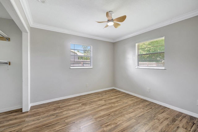 unfurnished bedroom with a ceiling fan, wood finished floors, baseboards, and ornamental molding