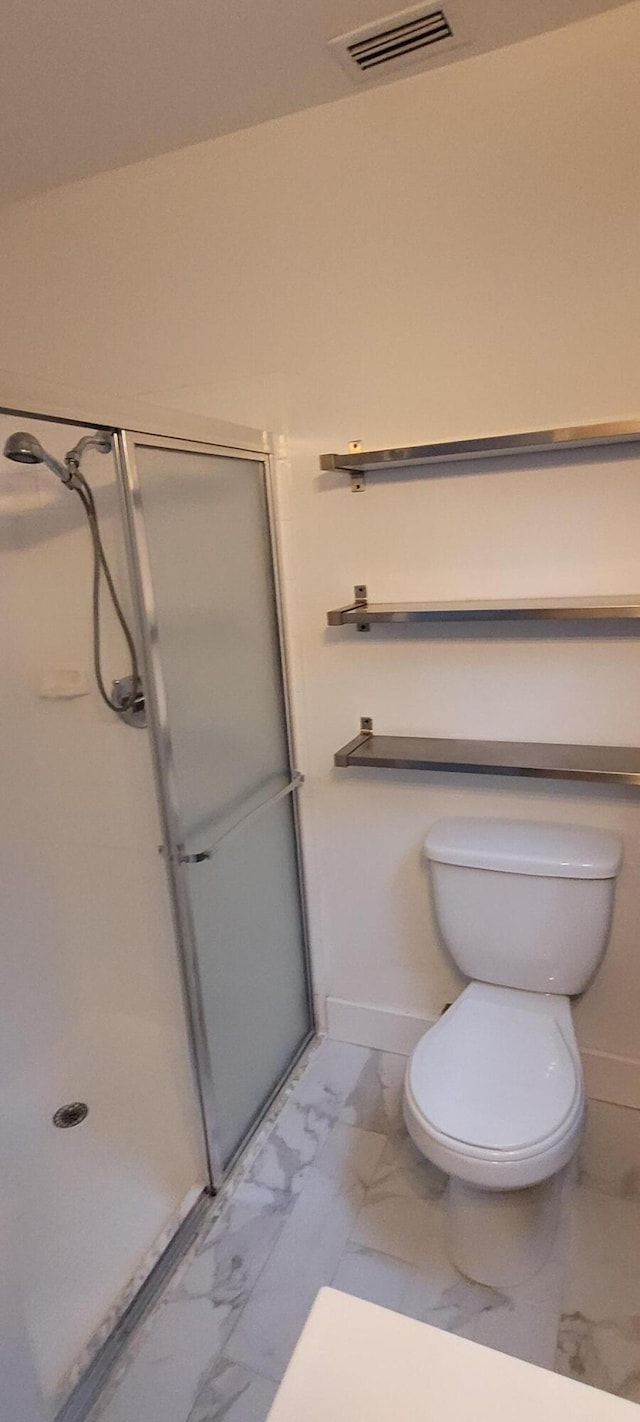 full bath featuring marble finish floor, visible vents, toilet, a shower stall, and baseboards