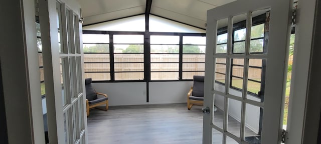 unfurnished sunroom with vaulted ceiling