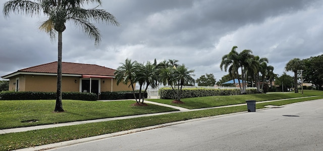 5151 Brian Blvd, Boynton Beach, FL 33472 - view of front facade featuring a tile roof, stucco siding, and a front yard
