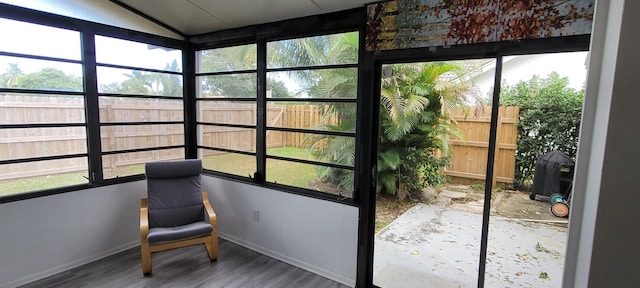 unfurnished sunroom with vaulted ceiling