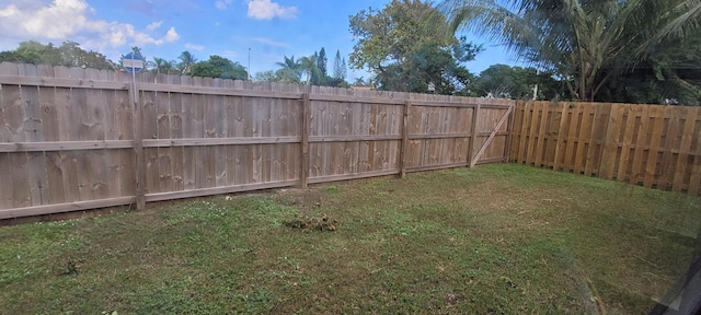 view of yard with a fenced backyard