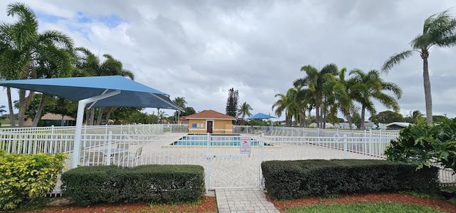 exterior space featuring a patio, a swimming pool, and fence