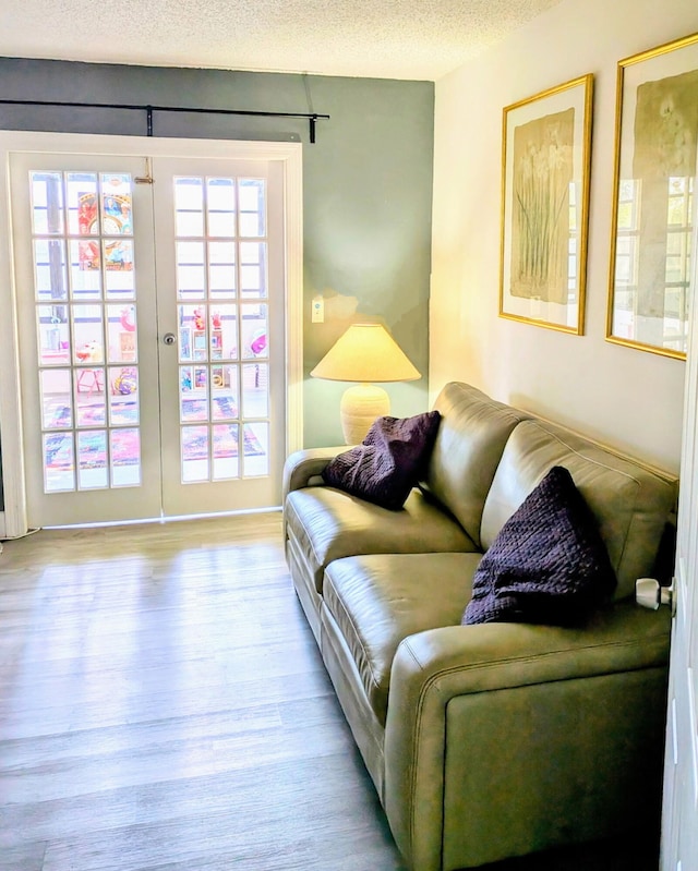 5151 Brian Blvd, Boynton Beach, FL 33472 - living room with wood finished floors, a textured ceiling, and french doors