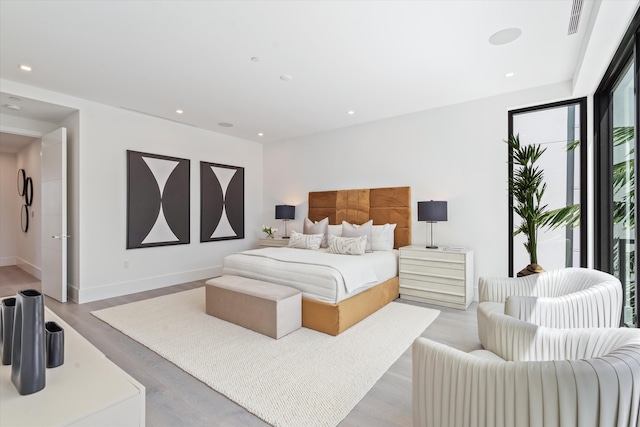 bedroom with recessed lighting, baseboards, and wood finished floors