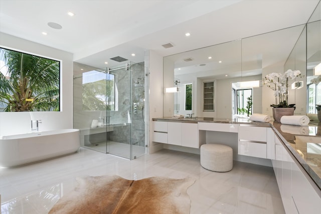 bathroom featuring a stall shower, a soaking tub, vanity, and recessed lighting