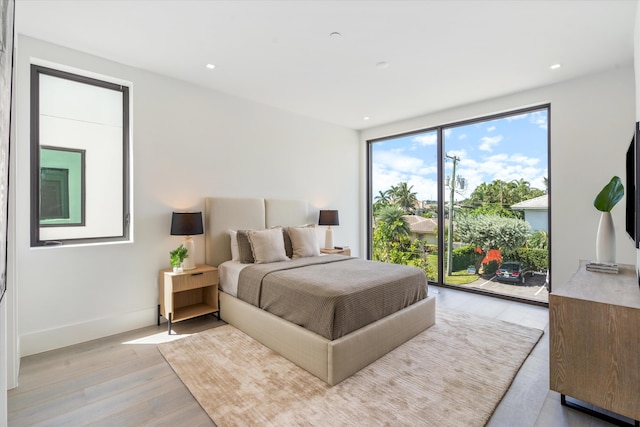 bedroom featuring light wood-style floors, access to outside, baseboards, and recessed lighting