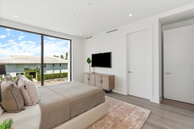 bedroom with light wood-type flooring, access to outside, visible vents, and recessed lighting