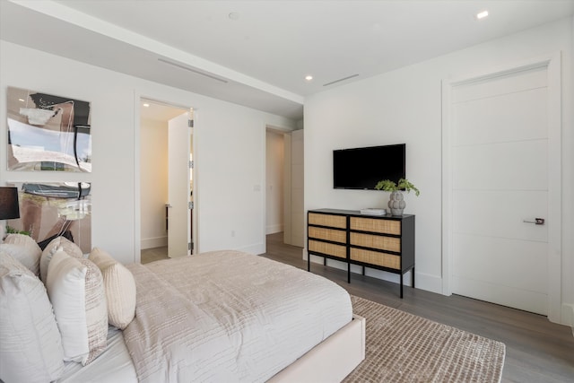 bedroom with baseboards, wood finished floors, and recessed lighting