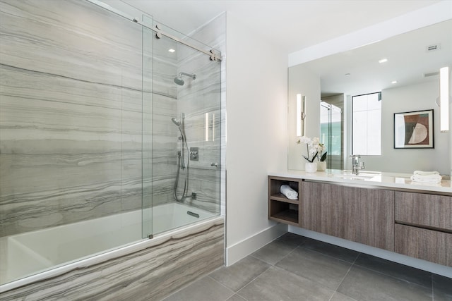 bathroom featuring tile patterned flooring, shower / bath combination with glass door, vanity, and baseboards