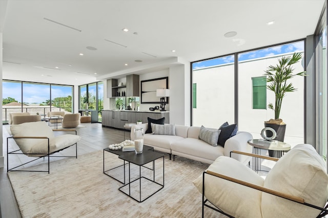 living area featuring light wood finished floors, recessed lighting, and floor to ceiling windows