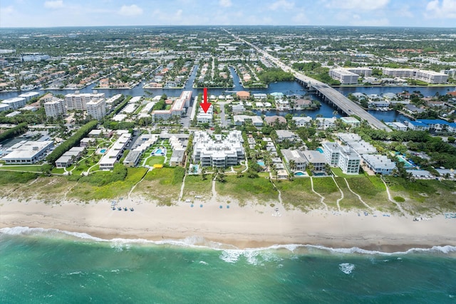 birds eye view of property featuring a beach view and a water view