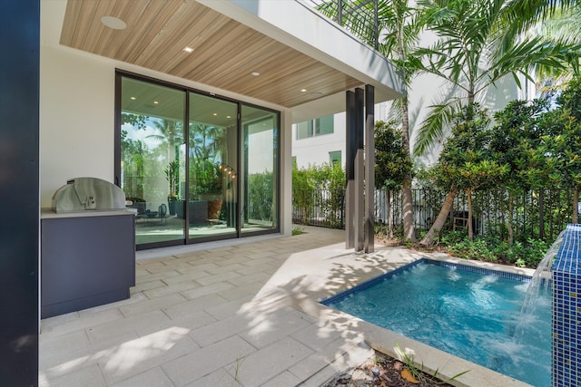 outdoor pool with a patio and fence