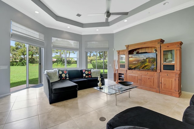 living room featuring a raised ceiling, visible vents, a high ceiling, and light tile patterned flooring