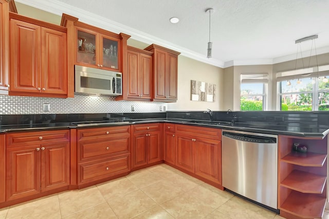 kitchen with dark countertops, stainless steel appliances, a peninsula, and pendant lighting