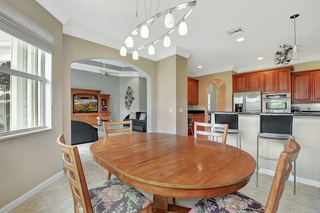 dining room featuring arched walkways, crown molding, light tile patterned floors, recessed lighting, and visible vents