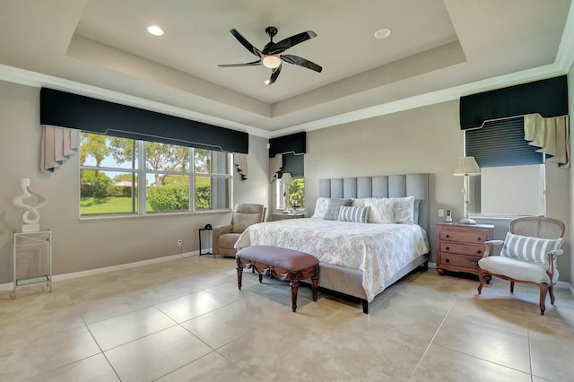 bedroom with baseboards, a tray ceiling, a ceiling fan, and light tile patterned flooring