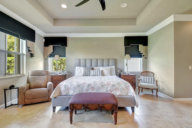 bedroom featuring a ceiling fan, a tray ceiling, baseboards, and light tile patterned floors